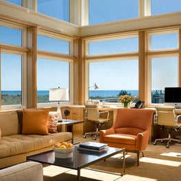 Modern beach house home office has stunning ocean views. 