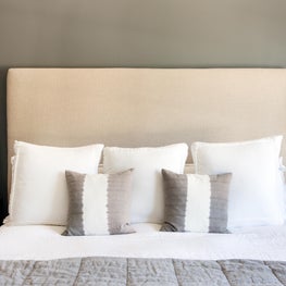 Soothing Modern Bedroom: Large Headboard, Simple Sconces, Neutral Bedding. 
