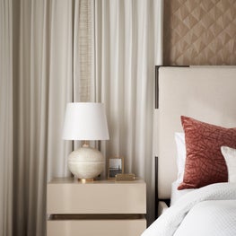 Sun-kissed neutrals fill the primary bedroom of University Place