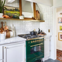Bohemian French Kitchen with Green Stove and Zellige Backsplash