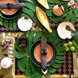 Botanical inspired tabletop for a jungalow lover using JIM THOMPSON products, vintage Russell Woodard plates, and Doi Din Dang pottery.