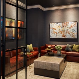 Media Room draped in rich wallcovering, navy lacquered ceilings and cognac leather seating. 