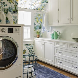 Laundry room with Schumacher wallpaper designed by Robin Gannon Interiors