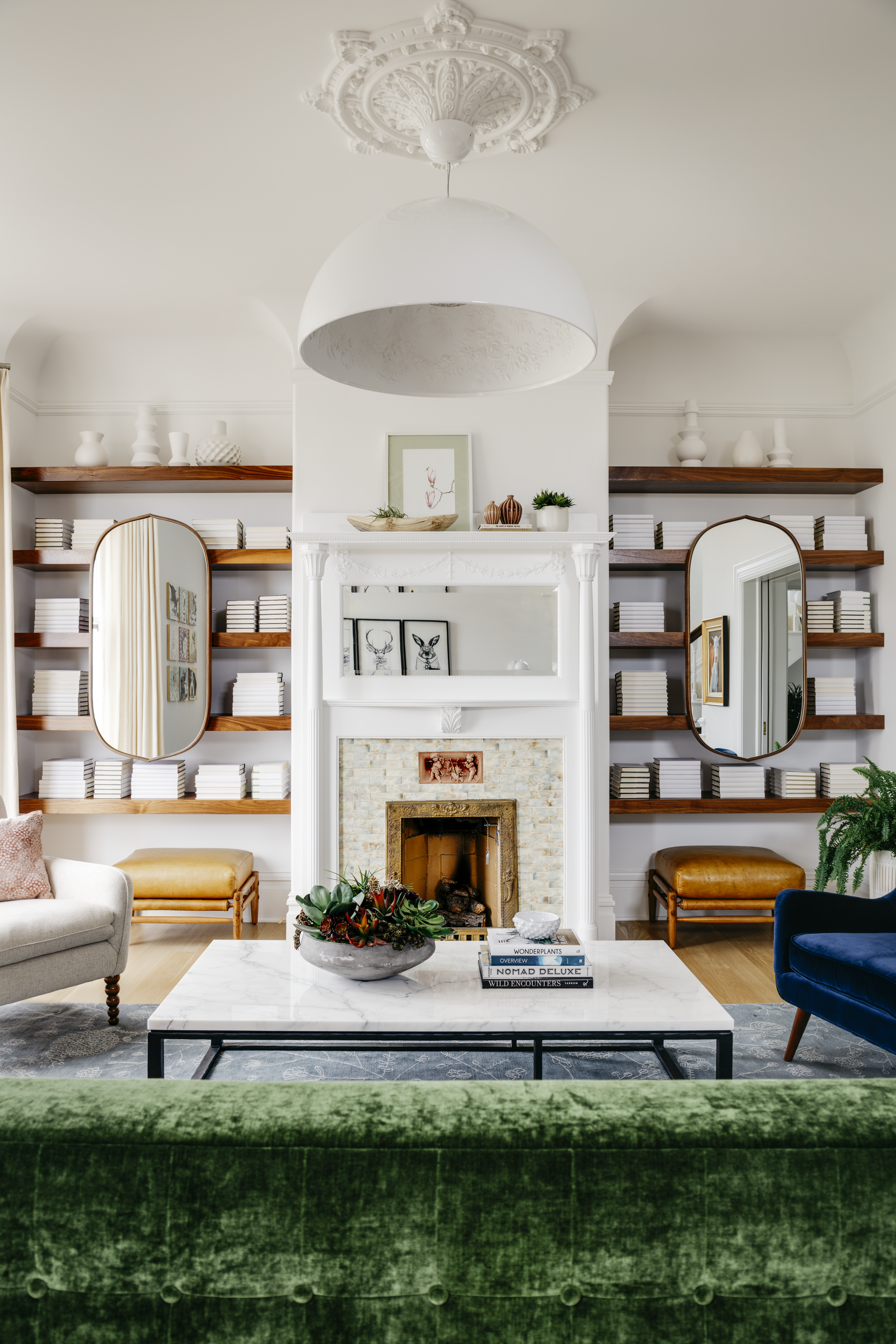 Bright, transitional living room with marble coffee table and built-in bookcases