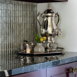 Portfolio: Silver serving tray in a glamorous Houston kitchen with black countertops