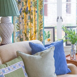 Layered blues, beiges, greens and yellows in living room