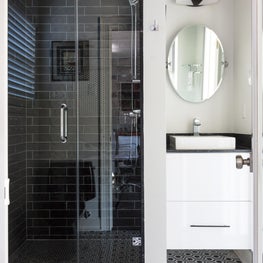 Guest Bathroom with marble flooring and glazed ceramic on shower walls 