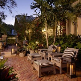 A tropical courtyard was created by using old Chicago brick .
