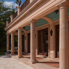 A stone loggia with a tiled barrel vault ceilling.