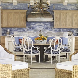 The backsplash in the kitchen is blue celestial marble, which conjures images of the vibrant Florida sky. The limed oak cabinetry incorporates Swedish diamond details and the floor is composed of randomly flagged, broken limestone.