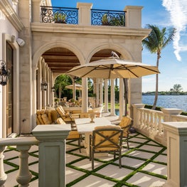 A waterfront sun terrace in a neoclassical Palm Beach Estate