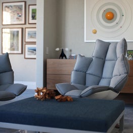 78th Street Playroom with Vintage Celestial Art, Lacquered & Upholstered Dune Ottoman and Sideboard, Table Top Sculpture and Handmade Wood Puzzles