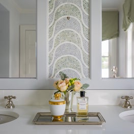 Bathroom with His and Hers Sinks, Tiled Panel, and Decorative Tray
