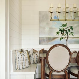 A blend of traditional chairs and built-in seating for a rustic breakfast nook