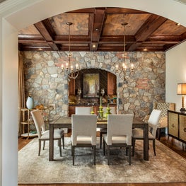 Rustic Dining Room with Stone Walls and Wooden Beams