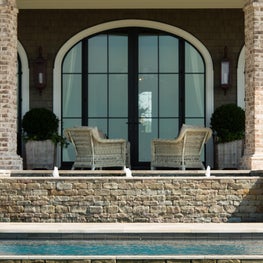 Infinity Edge Pool with Brick Column Loggia and Steel French Doors