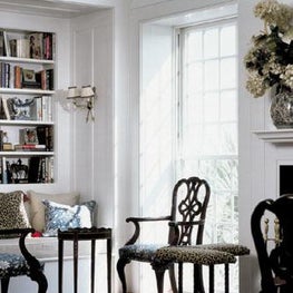 Architectural detailing coupled with dark wood furnishings create a cozy niche.