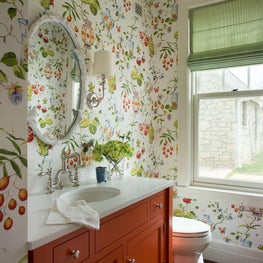 Statement bathroom with floral print wallpaper, burnt orange vanity
