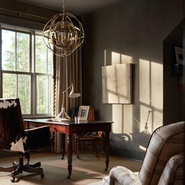 Luxurious home office with a custom lighting fixture