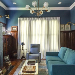 Blue Sitting Room with sleeper custom sleeper sofa and stacks of vintage books 