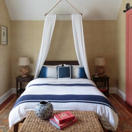 Painting the barn door pink is a fun & unexpected use of color in the guest room