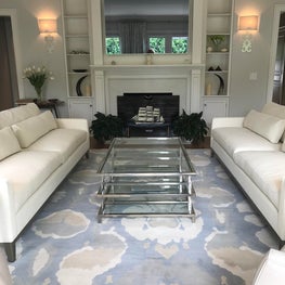 Elegant Living Room with glass coffee table, floral rug