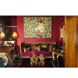 Seating area with over-sized oil painting and antique French daybed and pillows