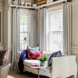 Eclectic transitional new traditional love seat reading nook with pink color pop