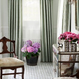 Kenilworth Foyer. Soft green serpentine valanced drapes with mosaic tile floor & mirrored chest.