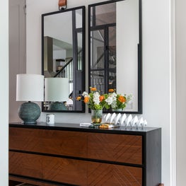Portfolio: Entryway with art mirrors and a dark wood console