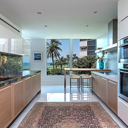 Contemporary Kitchen with two tone cabinets, colorful marble, and silk rug 