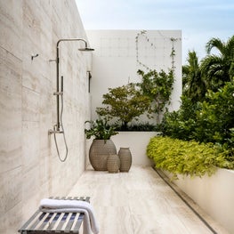 Outdoor shower surrounded by lush vegetation