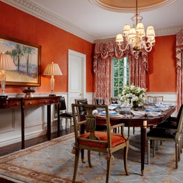 This colorful dining room has an elegant table that was imported from France.