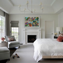 Natural light, a vaulted ceiling, and a calming color scheme create an atmosphere of Zen in this primary bedroom.