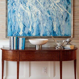 Classicly modern. Abstract artwork framed by traditional mill work and antiques.