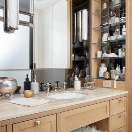 Upper West Side master bathroom with oak cabinetry and sheep skin stool