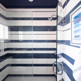 Navy striped wallpaper and tile in an Avalon, NJ beach house bathroom