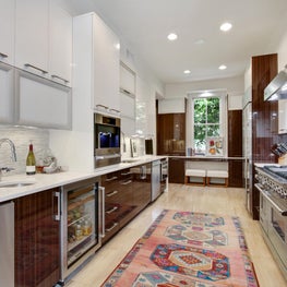 Galley Kitchen with high gloss laminates and vintage rug 