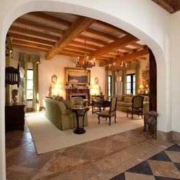 Reclaimed Natural beams in Living Room beyond Wide Plaster Arch with Stone Floor