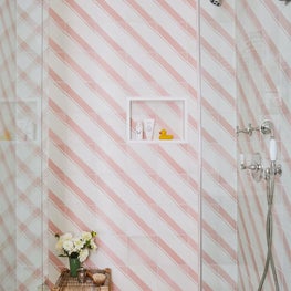 Contemporary kids bathroom with striped shower tile