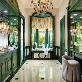 This bold green master bathroom blends with the luxurious outdoor landscapes.