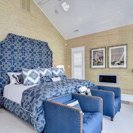 Custom navy headboard and bedding and grasscloth wallpaper 