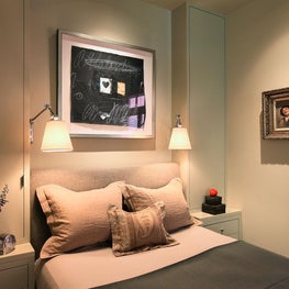 Warm, calm bedroom with over-bed wall sconces