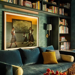 Library Room with Velvet Sofa and Green Walls