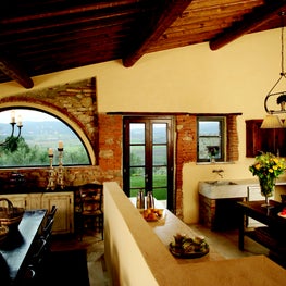 Arches and angles showcase this living and dining area in the hills of Tuscany