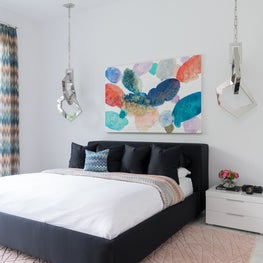 Portfolio: A playful, contemporary bedroom in the Friar Tuck residence featuring abstract pendants and artwork.
