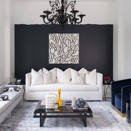 Portfolio: Contemporary living room with Hunt Slonem artwork and black chandelier, designed by Laura U.