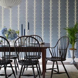 Glenview Dining Room. Blue grasscloth walls striped in white acanthus leaf with white chandelier & black windsor chairs.