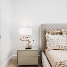 SLEEK CONTEMPORARY METALLIC RESIDENCE neutral guest room, animal print linens, beigh headboard