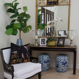 Vignette of console table and armchair in black wood, Asian-inspired details